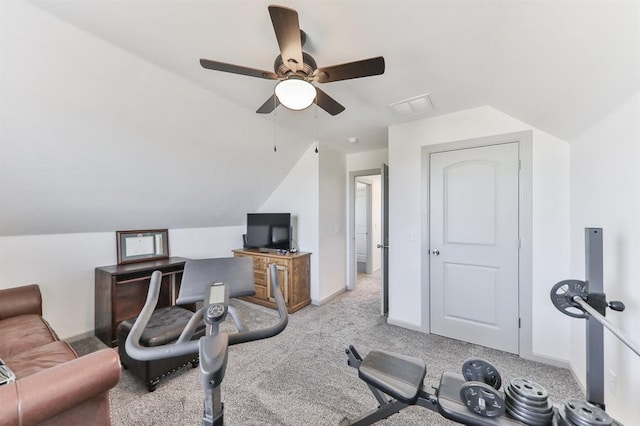 workout area featuring lofted ceiling, ceiling fan, light carpet, and baseboards