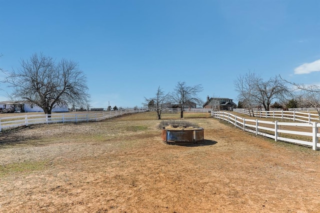 view of yard featuring fence and a rural view