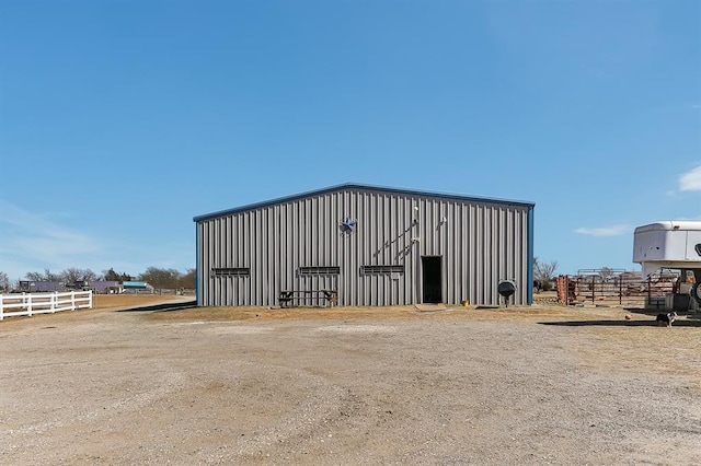 view of pole building with fence