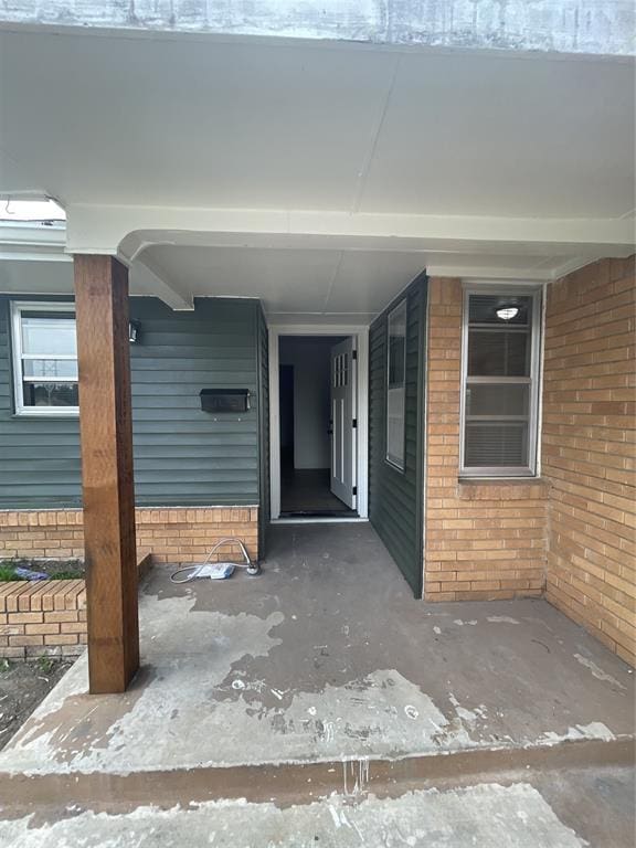 property entrance featuring brick siding