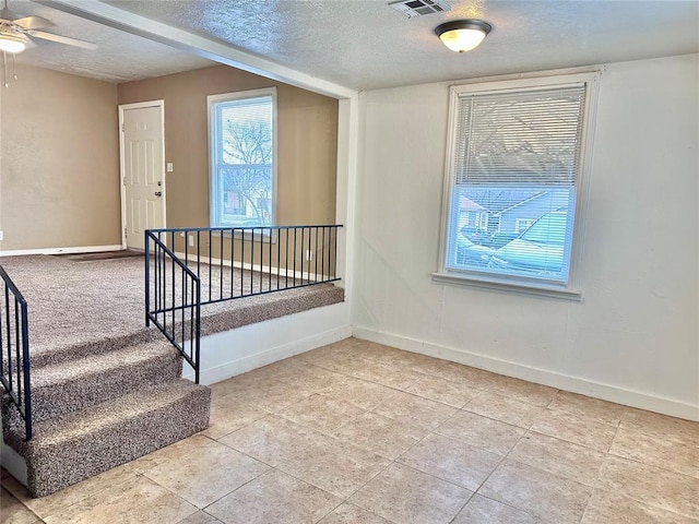 interior space with baseboards and a textured ceiling