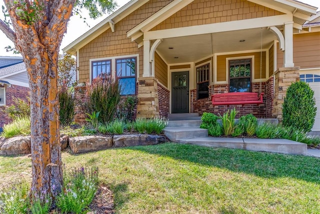 view of front of home with brick siding and a front yard