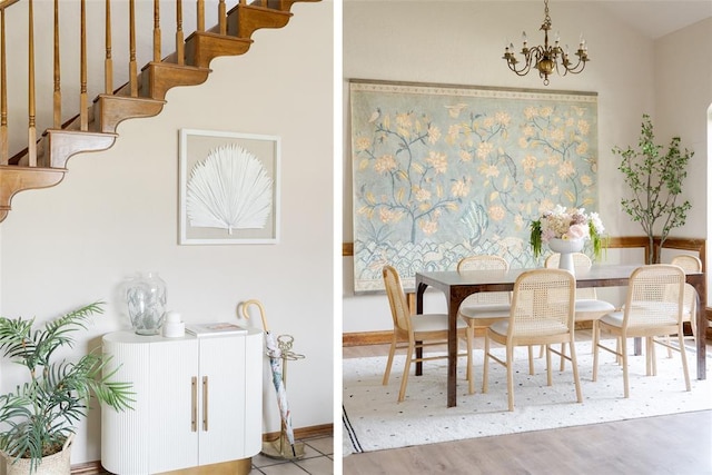 dining space featuring stairway, a notable chandelier, baseboards, and wood finished floors