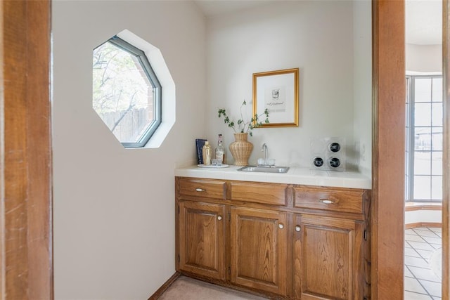 bathroom with vanity, baseboards, and tile patterned flooring