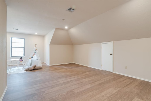 additional living space featuring visible vents, baseboards, and light wood-type flooring