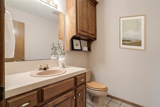 bathroom featuring visible vents, toilet, tile patterned flooring, and vanity