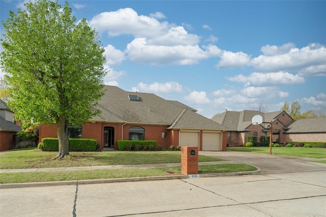 view of front of home with brick siding, a front lawn, a garage, and concrete driveway