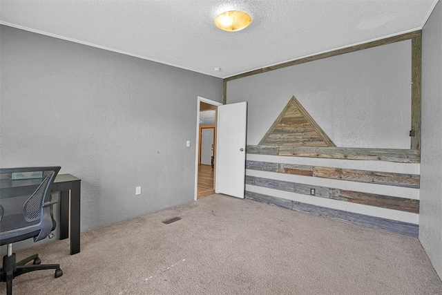 office area featuring visible vents, carpet flooring, a textured wall, and a textured ceiling