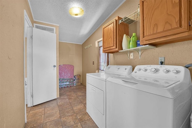 clothes washing area featuring a textured ceiling, a textured wall, visible vents, independent washer and dryer, and cabinet space