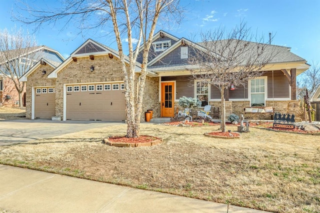 view of front of property with a garage, driveway, and brick siding