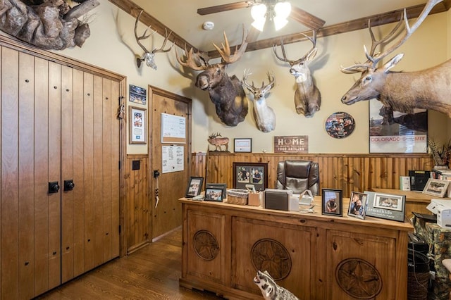 interior space featuring a wainscoted wall, ceiling fan, wood finished floors, and wooden walls