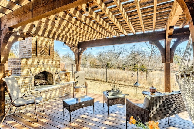 deck featuring a fenced backyard, a pergola, and an outdoor brick fireplace