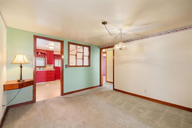 carpeted spare room with baseboards