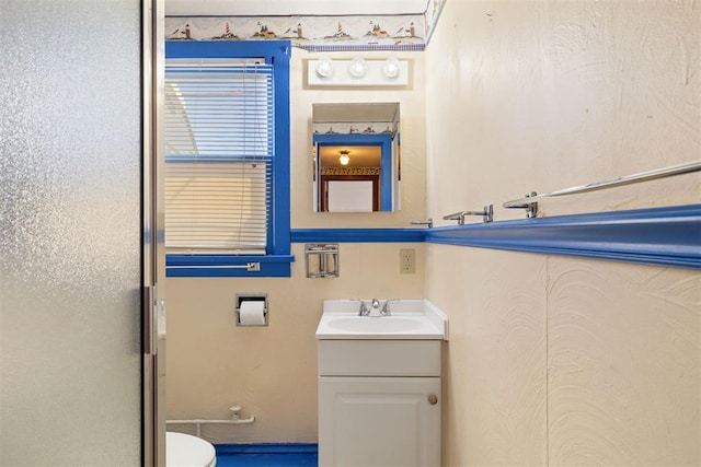 bathroom featuring toilet and vanity