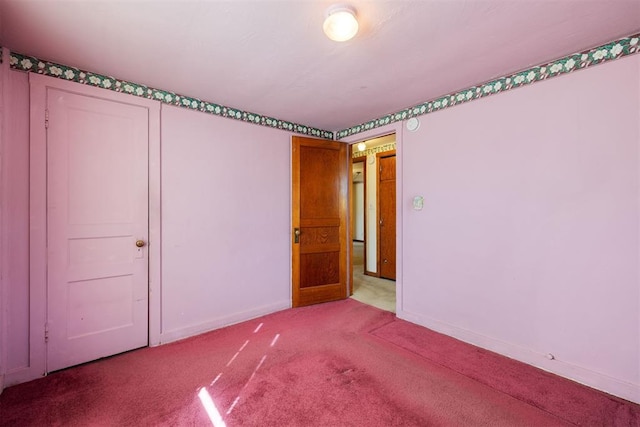 interior space featuring carpet flooring and baseboards