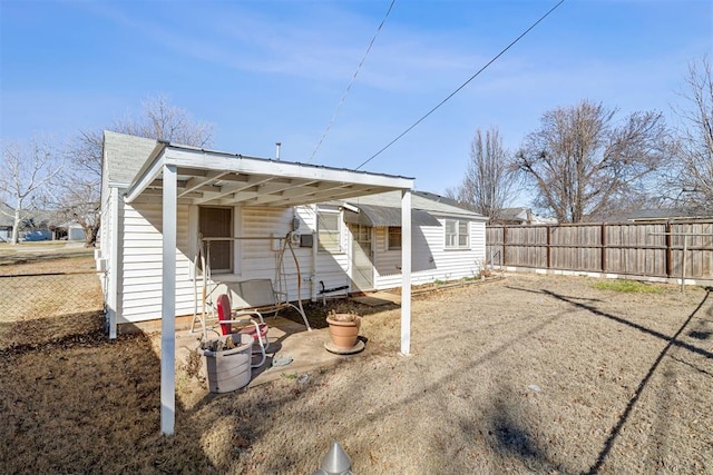 back of property featuring fence