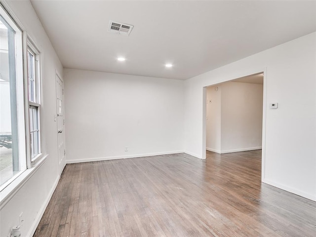 unfurnished room featuring recessed lighting, visible vents, baseboards, and wood finished floors