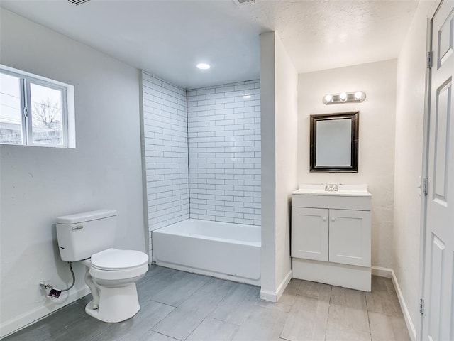 full bath with baseboards, vanity, and toilet