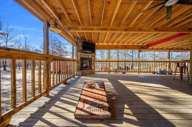 deck featuring an outdoor stone fireplace