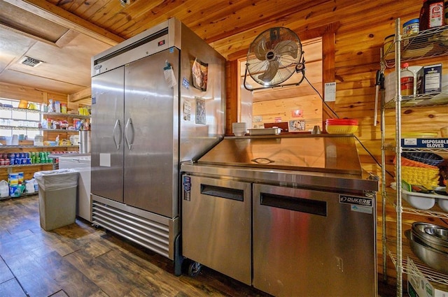kitchen with visible vents, wooden ceiling, dark wood-style flooring, built in fridge, and wooden walls