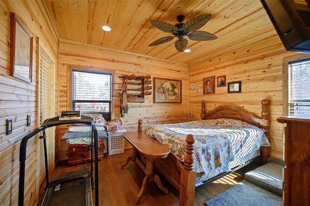 bedroom with wood walls, multiple windows, wooden ceiling, and wood finished floors