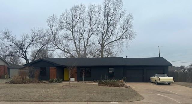 ranch-style house with cooling unit, driveway, and an attached garage