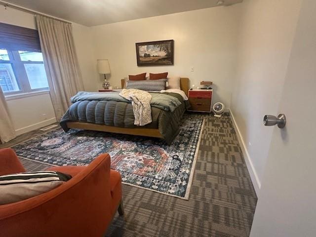 carpeted bedroom featuring baseboards