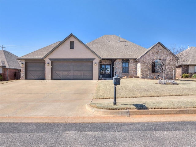 view of front of house with driveway, brick siding, an attached garage, and a shingled roof