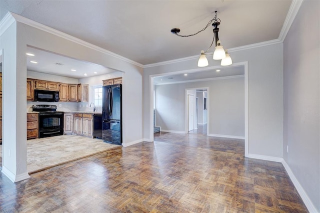 kitchen featuring baseboards, black appliances, light countertops, decorative light fixtures, and open floor plan