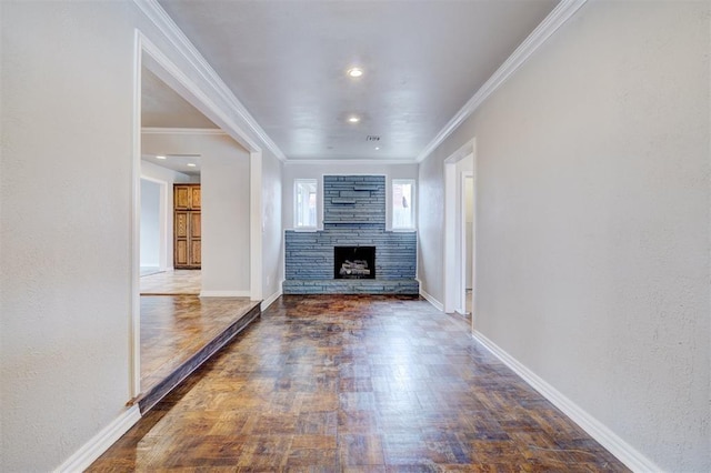 unfurnished living room with wood finished floors, baseboards, a stone fireplace, and ornamental molding