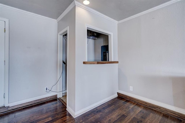 unfurnished room with crown molding, baseboards, and wood finished floors