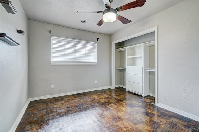 unfurnished bedroom with visible vents, wood finished floors, a closet, baseboards, and ceiling fan