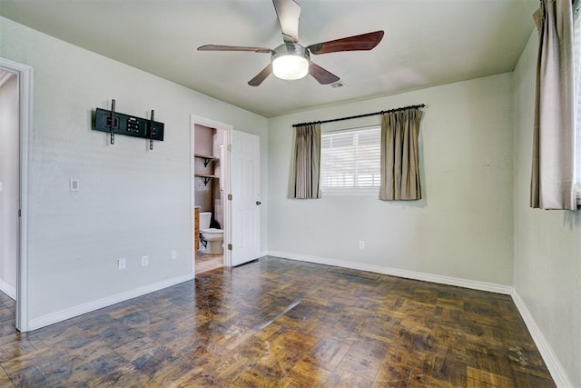 spare room with baseboards and ceiling fan