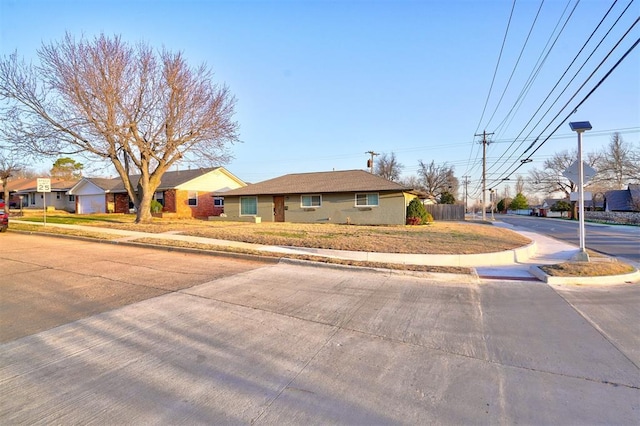 ranch-style home featuring fence