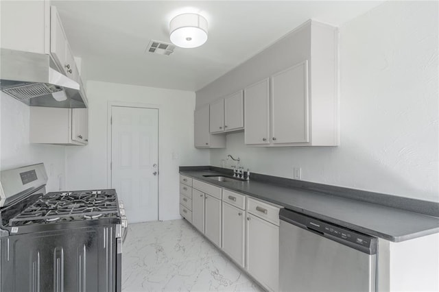 kitchen featuring visible vents, dark countertops, marble finish floor, stainless steel appliances, and a sink