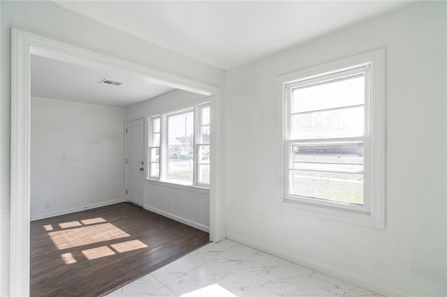 interior space with marble finish floor, visible vents, and baseboards