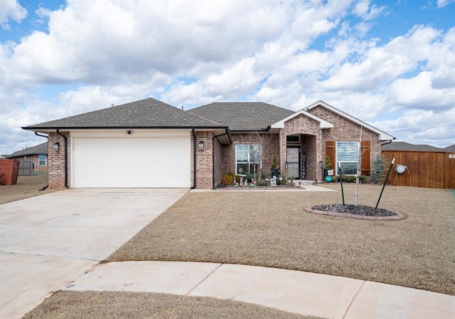 ranch-style house with brick siding, a shingled roof, fence, a garage, and driveway