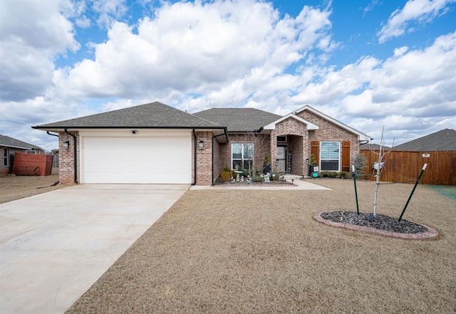 ranch-style house with fence, driveway, roof with shingles, an attached garage, and brick siding