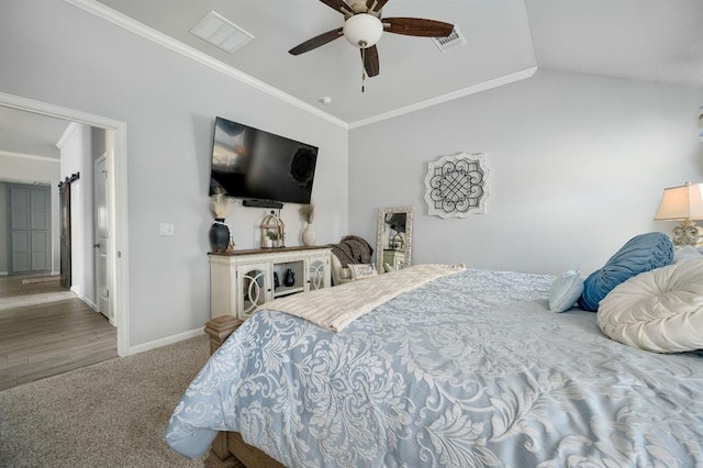 carpeted bedroom with visible vents, baseboards, ornamental molding, vaulted ceiling, and a ceiling fan