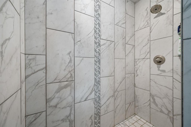 interior details featuring tiled shower