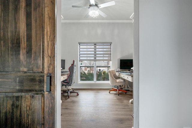 home office featuring crown molding, wood finished floors, baseboards, and ceiling fan