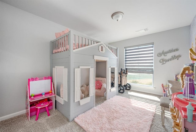 carpeted bedroom with visible vents and baseboards