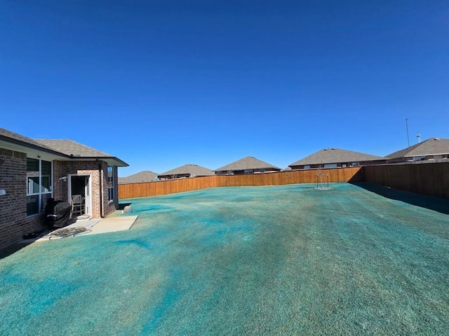 view of yard with a fenced backyard