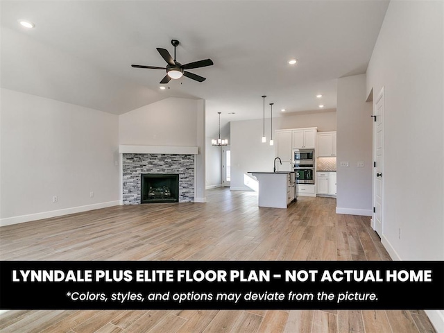 unfurnished living room with a sink, baseboards, light wood finished floors, and ceiling fan with notable chandelier