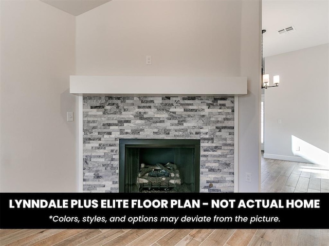 room details with visible vents, wood finished floors, and baseboards