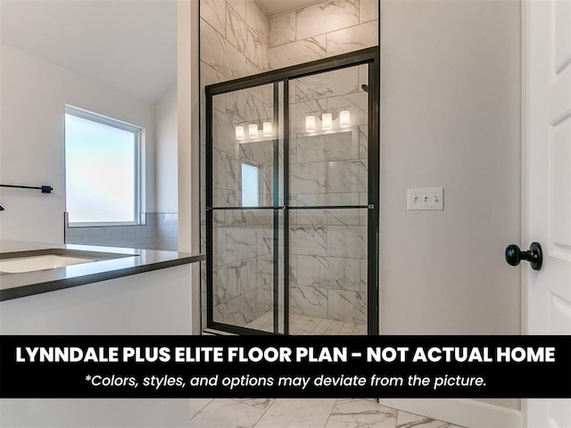 full bathroom with marble finish floor, a sink, and a shower stall