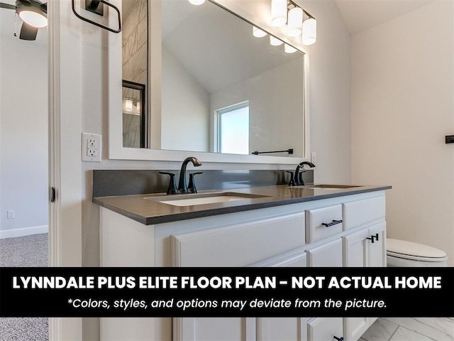 full bathroom featuring double vanity, toilet, vaulted ceiling, and a sink