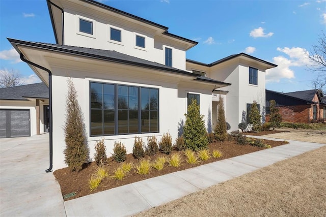 view of front of property featuring driveway and stucco siding