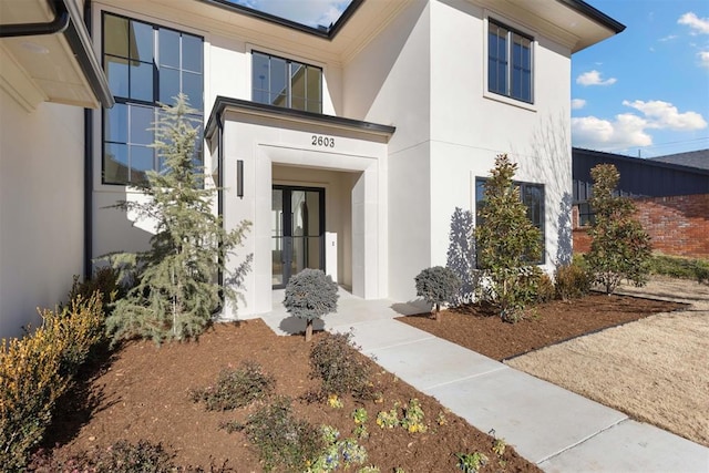 entrance to property with french doors and stucco siding