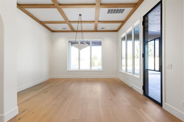 spare room with coffered ceiling, visible vents, baseboards, light wood-style floors, and beamed ceiling